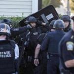 Members of the State Police and Boston Police SWAT Team on the corner of Belgrade Ave and Newburg St. in Roslindale on Tuesday, October 4, 2016 after gunfire was exchanged during a police operation. (Scott Eisen for The Boston Globe)