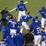 Toronto Blue Jays' Edwin Encarnacion, top right, is mobbed by teammates after hitting a walk-off three-run home run against the Baltimore Orioles during 11th inning of an American League wild-card baseball game in Toronto, Tuesday, Oct. 4, 2016. (Chris Young/The Canadian Press via AP)