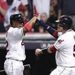 Cleveland Indians' Roberto Perez, right, celebrates with Francisco Lindor after scoring on a Jason Kipnis single against the Boston Red Sox in the fifth inning during Game 1 of baseball's American League Division Series, Thursday, Oct. 6, 2016, in Cleveland. (AP Photo/David Dermer)