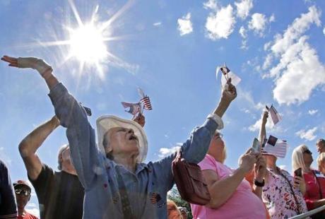 Ernestine Cuellar, of Boston's Charlestown neighborhood, raises her hands in prayer during a mass prayer rally on Boston Common, Tuesday, Aug. 30, 2016, in Boston held by evangelist Franklin Graham as part of a tour to urge evangelicals to vote. Graham's rally is a stop on his 50-state 