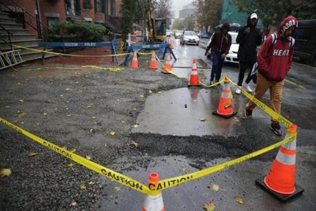 The scene Saturdayon Dartmouth Street where a water main break flooded a trench and two workers were killed Friday.
