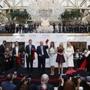 Republican presidential candidate Donald Trump, accompanied by, from left, Donald Trump Jr., Eric Trump, Trump, Melania Trump, Tiffany Trump and Ivanka Trump, holds up a ribbon during the grand opening ceremony of the Trump International Hotel- Old Post Office, Wednesday, Oct. 26, 2016, in Washington. (AP Photo/ Evan Vucci)