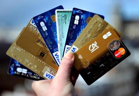A person held up credit cards. 
