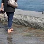 BOSTON, MA - 10/17/2016:Toursit Gail Garrett (cq) from New York enjoys going barefoot at Long Wharf with a flooding tide. Bostonâ??s waterfront and high tides known as â??King Tide.â?? The relative position of the sun and moon created a tide nearly 2 1/2 feet higher than average. (David L Ryan/Globe Staff Photo) SECTION: METRO TOPIC18tides