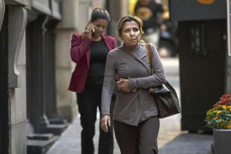 Johanna Herrero, a lawyer, (left) and her mother, Stella Figueredo, made their way along State Street in Boston.
