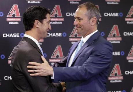 New Arizona Diamondbacks manger Torey Lovullo, right, is greeted by Diamondbacks' Executive Vice President and General Manager Mike Hazenor for the first time as manager, Monday, Nov. 7, 2016, at Chase Field n Phoenix. (AP Photo/Matt York)

