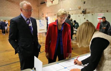 CAMBRIDGE MA - 11/08/2016: Checking in to vote L-R Bruce Mann with his wife US Sen Elizabeth Warren at Ward 8 in the Graham and Parks School in Cambridge. The 2016 presidential election, voter turnout at polling places (David L Ryan/Globe Staff Photo) SECTION: METRO TOPIC 09turnout

