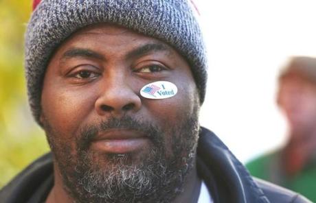 Boston, MA -11/8/2016 - Jermaine Johnson (cq), said he put the ?I Voted? sticker on his face to ?help the young generation see that I voted today.? The 36-year-old said he considered Donald Trump (cq) for a while, ?but he started getting messy.? Voting activity is photographed near the Margarita Muniz Academy (cq), at 20 Child Street in Jamaica Plain. Photo by Pat Greenhouse/Globe Staff Topic: 09turnout Reporter: XXX

