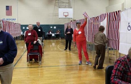 11/8/16-- BEDFORD , MA - Voters are assisted as they enter voting booths at the John Glenn Middle School Gym in Bedford, the only polling station in town, which opened at 6a.m. (Boston Globe staff photo: Joanne Rathe topic: section: metro) 
