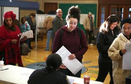 Boston, MA -11/8/2016 - Checking out is Boston Latin School student Juliana Quiles (cq), center, who just turned 18 last week. ?I?m the first of all my friends to be able to vote. So I think having that right, as a senior, is a big deal.? People turn out to vote in Hyde Park (30 Millstone Road). Photo by Pat Greenhouse/Globe Staff Topic: 09turnout Reporter: XXX
