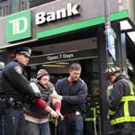 One of the protestors who blocked the entrance of a TD Bank on Winter Street was arrested. 