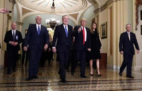 Trump walked with Mitch McConnell and Mike Pence on Capitol Hill. 
