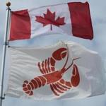 A Canadian flag and a lobster flag flew above the harbor in Charlottetown.