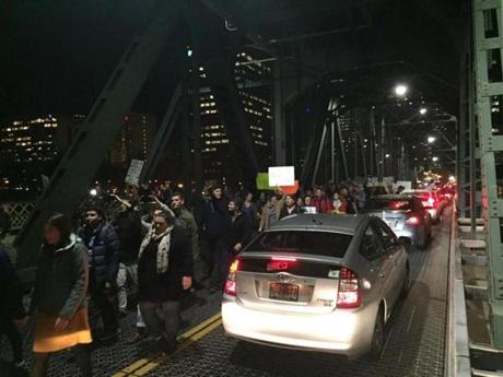 Protesters cross the Hawthorne Bridge in Portland, Ore., on the third day of protests over the results of the 2016 U.S. presidential election, Thursday, Nov. 10, 2016. President-elect Donald Trump fired back on social media after demonstrators in both red and blue states hit the streets for another round of protests, showing outrage over the Republican's unexpected win. (Jim Ryan/The Oregonian via AP)
