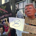Protesters held banners during an anti-Donald Trump rally outside CNN studios in Los Angeles on Sunday.
