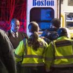  An injured Boston Police officer is loaded into an ambulance after being struck by a suspect in a car near Dublin House on Stoughton St. in Dorchester on Wednesday, November 23, 2016. Multiple officers were injured by the suspect in a car. (Scott Eisen for The Boston Globe)
