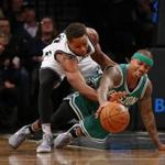 New Jersey Nets guard Yogi Ferrell, left, and Boston Celtics guard Isaiah Thomas scramble for the ball during the first half of an NBA basketball game in New York, Wednesday, Nov. 23, 2016. (AP Photo/Rich Schultz)