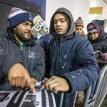 Doug Contreras and Hector Garcia wait in line at the Best Buy in Watertown which opened at 1am on Black Friday in 2014. 