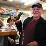 Boston-11/26/2016- Nobel Garcia, owner of the El Oriental de Cuba restaurant celebrated by opening a 20-year-old bottle of sprarkling apple cider with the words: 