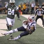 New England Patriots wide receiver Malcolm Mitchell (19) comes down with a touchdown catch in front of New York Jets cornerback Darrelle Revis (24) during the second quarter of an NFL football game, Sunday, Nov. 27, 2016, in East Rutherford, N.J. (AP Photo/Bill Kostroun)