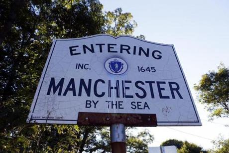 Even though the sign at the town line eschews the hyphens, the official name is Manchester-by-the-Sea.
