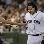 8/10/2005:Boston,MA: GLOBE STAFF PHOTO/JIM DAVIS:Red Sox LF Manny Ramirez gets a hand from a front row fan as he heads for the dugout following his fourth inning home run. Library Tag 08112005 Sports