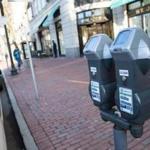 Parking meters line the street on Boylston Street in Boston.