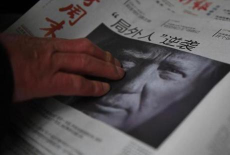 This file photo taken on November 10 showed a man buying a newspaper featuring a photo of US President-elect Donald Trump.

