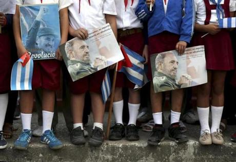 epa05655198 Cuban students hold pictures of Fidel Castro as they gather to watch the motorcade carrying the ashes of late Cuban leader Fidel Castro in Santa Clara, Cuba, 1 December 2016. The urn containing the ashes of Castro is on a four-day journey across the island, a funeral procession that will end in Santiago de Cuba, where his funeral will be held on 04 December 2016. EPA/ORLANDO BARRIA correct date
