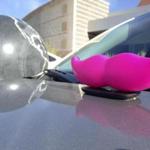 The signature pink mustache of the ride-sharing app Lyft sat on the hood of a vehicle in Albuquerque, N.M.