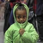 BOSTON, MA - 12/06/2016: Kaira Payne (cq) 4 yrs old with her new coat went shopping with her grandmother Mahogony Payne (cq) of Mattaphan. The Massachusetts Salvation Army will host its 17th annual Christmas Castle event to help thousands of local families in need at The Castle at Boston Park Plaza. The event makes the holiday season brighter for more than 12,000 Boston area family members who will have the opportunity to shop for warm coats and toys and receive a voucher for a warm Christmas dinner. The Christmas Castle also brings together nearly two dozen Boston area businesses and organizations and approximately 400 volunteers that help staff the event. (David L Ryan/Globe Staff Photo) SECTION: METRO TOPIC 07castle