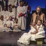 Kaleisha Chance, as Mary, holds Logan Watson (baby Jesus), while Derek Louizia (Joseph) and members of Black Persuasion look on in ?Black Nativity,? presented by National Center of Afro-American Artists.  