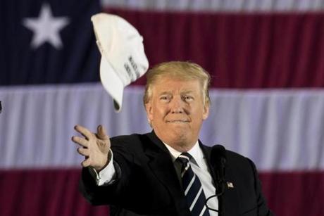 BATON ROUGE, LA - DECEMBER 9: President-elect Donald Trump tosses a 'Make America Great Again' hat into the crowd while speaking at the Dow Chemical Hangar, December 9, 2016 in Baton Rouge, Louisiana. Trump is in Louisiana to campaign for Republican U.S. Senate candidate John Kennedy. (Photo by Drew Angerer/Getty Images) *** BESTPIX ***
