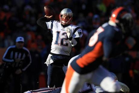 DENVER, CO - DECEMBER 18: Quarterback Tom Brady #12 of the New England Patriots passes against the Denver Broncos in the first quarter of a game against the Denver Broncos at Sports Authority Field at Mile High on December 18, 2016 in Denver, Colorado. (Photo by Sean M. Haffey/Getty Images)
