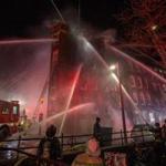 Boston Fire works to surround and extinguish a 5-alarm fire at 52 Hull St. in the North End early on Sunday, December 25, 2016. (Scott Eisen for The Boston Globe)