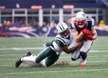 Foxborough, MA 12/24/16 Jets Buster Skrine tackles Patriots Julian Edelman in the second quarter. New England Patriots vs. New York Jets at Gillette Stadium. (John Tlumacki/Globe Staff)
