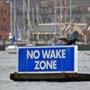 BOSTON, MA - 6/03/2016: A sign posted floating in Boston Harbor saying NO WAKE ZONE makes a good perch for this bird. (David L Ryan/Globe Staff Photo) SECTION: METRO TOPIC stand alone photo