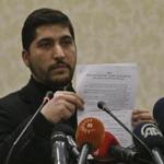 Osama Abu Zeid of the Free Syrian Army held up what he said was a copy of the cease-fire agreement during a news conference Thursday in Ankara, Turkey.