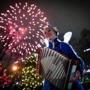 Boston, MA - 12/31/2015 - Performer Sophie Crafts play her accordion as fireworks go off during first night festivities in the Public Garden Boston, MA, December 31, 2015. (Keith Bedford/Globe Staff) 