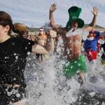 South Boston, MA -- 1/1/2017 - Swimmers including Billy Williams, of Medford (C) charged into the water during the L Street Brownies annual New Year's Day polar plunge into Dorchester Bay. (Jessica Rinaldi/Globe Staff) Topic: 02brownies Reporter: 