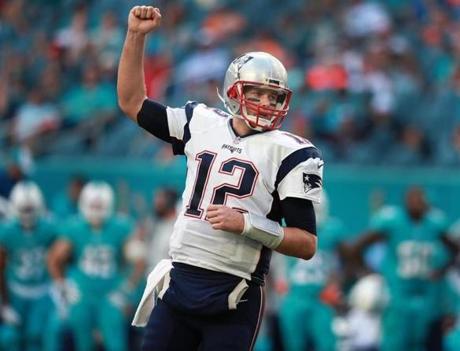 Miami Gardens, FL 1-1-17: Patriots quarterback Tom Brady pumps his fist after teammate LeGarrette Blount (not pictured) scored a fourth quarter touchdown that helped seal New England's victory that clinched home field advantage for the team throughout the AFC playoffs. The New England Patriots visited the Miami Dolphins in a regular season NFL football game at Hard Rock Stadium. (Globe Staff Photo/Jim Davis) reporter: mcbride topic: Patriots 
