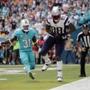 New England Patriots tight end Martellus Bennett (88) grabs a touchdown pass as Miami Dolphins free safety Michael Thomas (31) is late with the tackle, during the first half of an NFL football game, Sunday, Jan. 1, 2017, in Miami Gardens, Fla. (AP Photo/Alan Diaz)