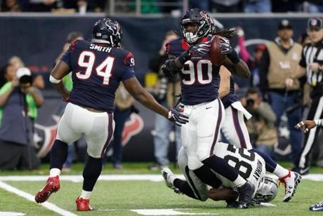 HOUSTON, TX - JANUARY 07: Jadeveon Clowney #90 of the Houston Texans tips and intercepts a pass from Connor Cook #8 of the Oakland Raiders during the first quarter of their AFC Wild Card game at NRG Stadium on January 7, 2017 in Houston, Texas. (Photo by Bob Levey/Getty Images)
