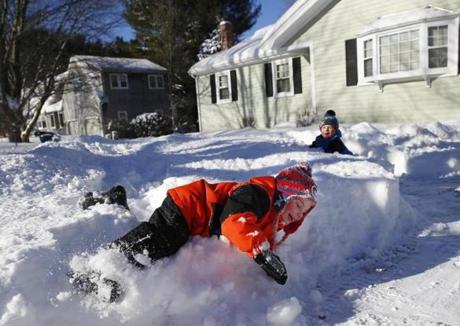 East Bridgewater, MA -- 1/8/2017 - Damon McNamee, 4, rolls in a snowbank in his front yard as he plays with his two and a half year old brother, Ethan, (R) in East Bridgewater where snow totaled 20.5 inches. (Jessica Rinaldi/Globe Staff) Topic: 09snow Reporter: 
