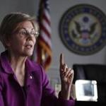 Sen. Elizabeth Warren, D-Mass. gestures as she answers a question during an interview at her office in Boston, Thursday, Dec. 15, 2016. (AP Photo/Charles Krupa)