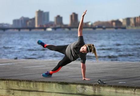Sarah Coughlin from Dorchester practiced her yoga routine on a dock on the Charles River Esplanade on Thursday. 
