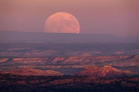 A nearly-full ?supermoon? rises at dusk above the Valley of the Gods in the Bear Ears National Monument. 
