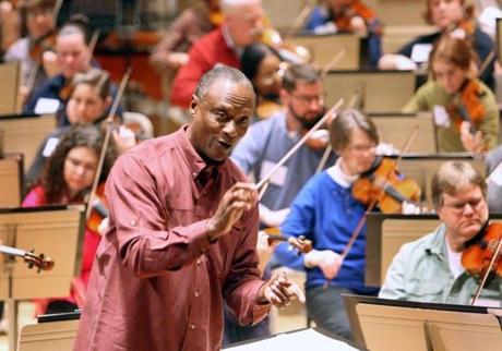 Conductor Thomas Wilkins led a group of amateur musicians in rehearsal at Symphony Hall. 
