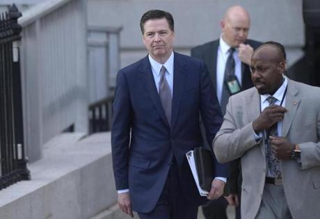 FBI Director James Comey (left) walked out of the Eisenhower Executive Office Building at the White House complex on Friday.  
