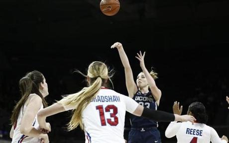 Connecticut forward Katie Lou Samuelson (33) attempts a shot as SMU forwards Alicia Froling (10), Klara Bradshaw (13) and guard Mikayla Reese (4) defend during the first half of an NCAA college basketball game, Saturday, Jan. 14, 2017, in Dallas. (AP Photo/Brandon Wade)
